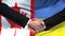 Canada and Ukraine handshake international friendship relations, flag background