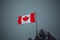 Canadian flag waving in the strong wind as bad weather approaches and the sky turns grey. Beautiful color contrast