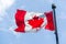 Canadian Flag in the wind over blue sky