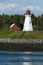 Canadian Lighthouse On Rocky Coast During Low Tide