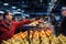 Canadian man tasting samples of oranges in Jean Talon Market, in Montreal, Quebec. It is a major landmark & a symbol of Quebec