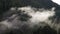 Canadian Mountain Landscape Covered in Clouds. Aerial Nature Background.