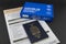 Canadian passport in the foreground and Covid 19 at home specimen collection test kit with government mandatory traveler quarantin