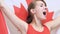 Canadian Young Woman Celebrates holding the Flag of Canada in Slow Motion