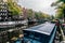 Canal in Amsterdam The Netherlands with several houseboats and water reflection