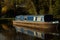 Canal barge narrow boat in water surrounded by trees