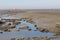 A canal in a big mudflat in the westerschelde sea in zeeland