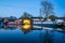 Canal boat dry dock for narrowboat moored repairs at night illuminated and lit up reflecting on long exposure still River Trent