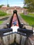 Canal boat in lock in front of bridge