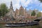 Canal boat and Old Church in Amsterdam, Holland