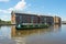 A canal boat passes through Gloucester Docks heading towards the Gloucester & Sharpness Canal,  Gloucester, UK