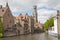 A canal in Bruges, Belgium, with the famous Belfry in the background.