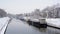 Canal in the city of Ghent with living boats on a winter day with snow