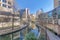 Canal flanked by pathways on a sunny day in San Antonio River Walk Texas