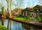Canal in Giethoorn at sunny winter morning, Netherlands. Giethoorn is a village in the Dutch province of Overijssel