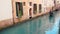 Canal with gondolas with tourists in Venice