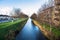 Canal lined with bare tree in central Dublin in winter