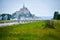 Canal makes its way between fields and farmland up to Mont Saint Michel, FranceMont Saint Michel, France