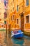 Canal and moored old boat in Venice