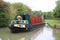 A canal narrowboat cruising along canal
