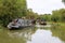 Canal narrowboats cruising along canal