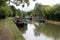 Canal narrowboats moored alongside English canal