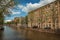 Canal with old brick buildings and boats in Amsterdam