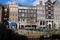 canal and old brick habitation buildings in amsterdam - the netherlands