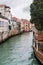 Canal and old houses in Venice in rain