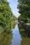 Canal with reflection of trees, houses in background in the Hague, the Netherlands