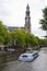 Canal scene with tourist boat westekerk amsterdam