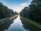 Canal Serenity: Tranquil Waters Amidst Towering Trees