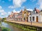 Canal and tower of church in old town of Bolsward, Friesland, Ne