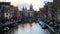 Canal and townhouses in the historic heart of the city, Basilica of Saint Nicholas in the background, Amsterdam, Netherlands