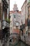 Canal in Venice with docked gondola and boats,