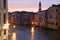 Canal in Venice with docked gondola and boats