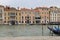 Canal in Venice with docked gondola and boats,