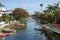 Canals, Homes, and a Bridge Crossing the Canal of Venice, California During a Sunny Day