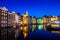 Canals and tradition house in Amsterdam at night. Amsterdam is the capital and most populous city of the Netherlands