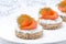 Canape with rye bread, cream cheese, salmon and greens