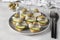 Canape with salted herring, olives and cucumber on white bread toasts on gray background, Closeup