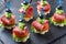 Canape on skewers with vegetables and sausage