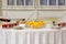 Canapes, fruits and beverages on the buffet table. Stand-up meal