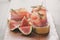 Canapes with jamon and figs on table