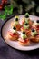 CanapÃ© on skewer from bread baguette with toast cheese, sausage, tomato, cucumber and olives. Traditional snack for the New Year.