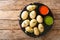 Canarian food wrinkly potatoes are boiled unpeeled potatoes served with two local sauces close-up on a slate plate. horizontal top