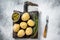 Canary Islands dish Papas Arrugadas, wrinkly potatoes with Mojo verde green sauce. White background. Top view