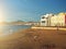 Canary Islands sea beach panorama at sunset, coast shore landmark with seaside architecture and mountains on foreground