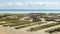 Cancale coast at low tide in a summer day, oyster farms in the foreground. Brittany, France.