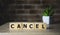 CANCEL word made with building blocks, business concept.